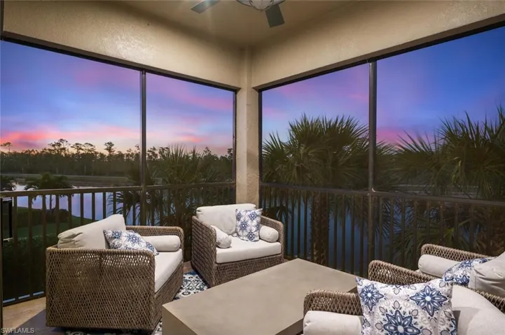 Sunroom featuring a water view and a ceiling fan
