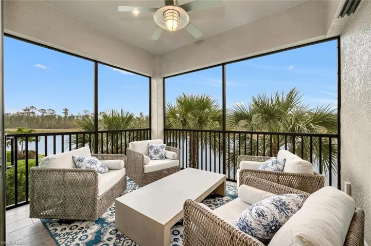 Sunroom / solarium with a water view and ceiling fan