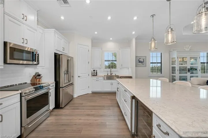 Kitchen with a sink, visible vents, a wealth of natural light, and stainless steel appliances