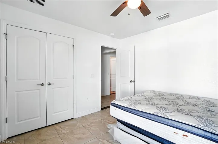 Bedroom with a closet and a ceiling fan