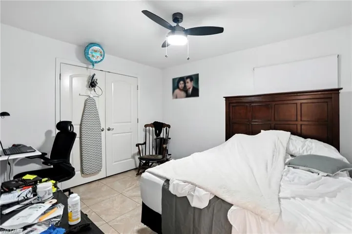 Bedroom featuring light tile patterned floors and a ceiling fan