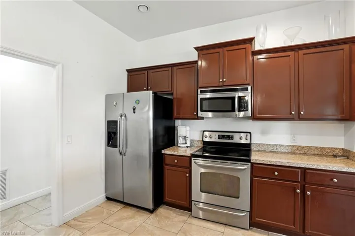 Kitchen with stainless steel appliances and light countertops