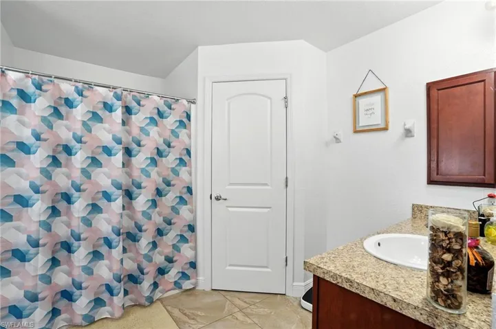 Full bathroom featuring vanity and a shower with shower curtain