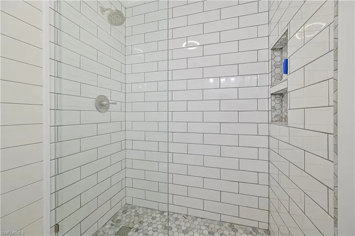 Subway tiled shower with seamless shower wall