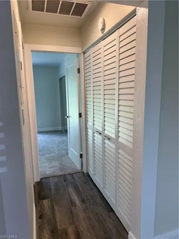 Hallway featuring dark hardwood / wood-style flooring