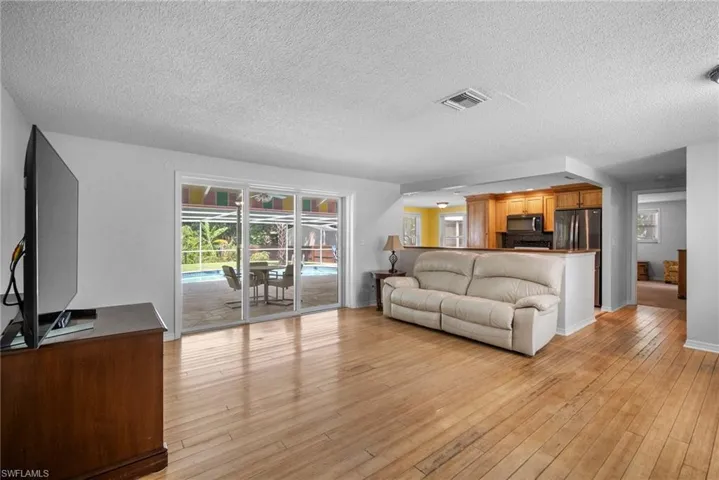 Living room featuring light hardwood / wood-style flooring and a textured ceiling