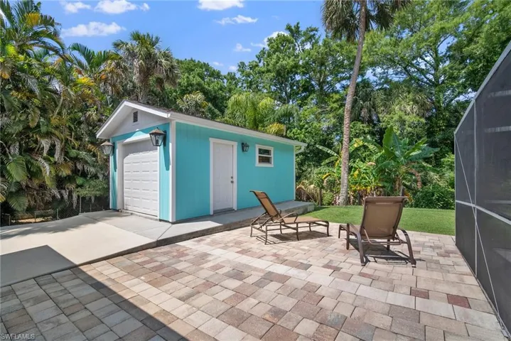 View of patio featuring a garage and an outdoor structure