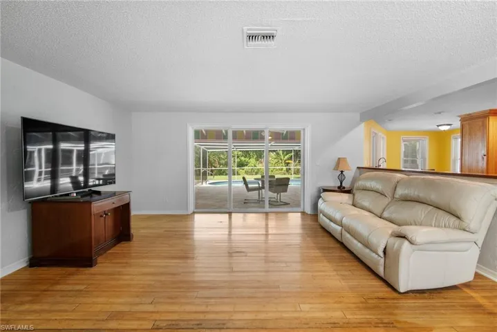 Living room featuring light hardwood / wood-style floors and a textured ceiling