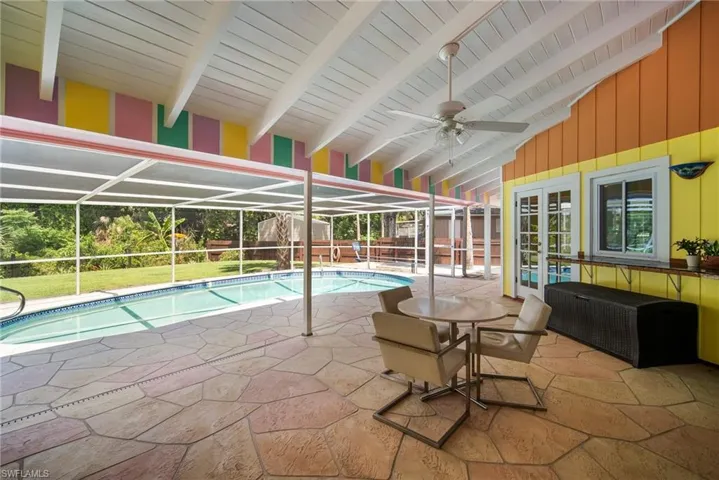 View of swimming pool featuring ceiling fan
