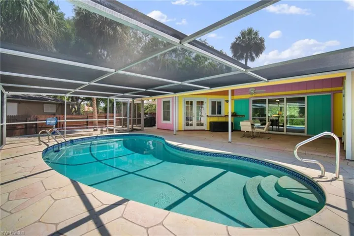 View of pool featuring french doors, a lanai, and a patio