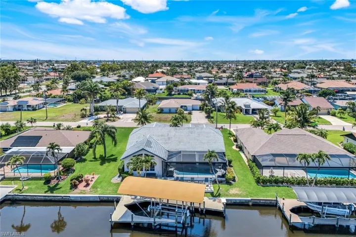 Aerial perspective of suburban area featuring a nearby body of water