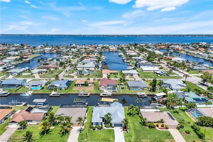 Aerial view of residential area featuring a large body of water