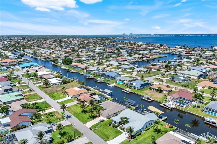 Aerial perspective of suburban area with a nearby body of water