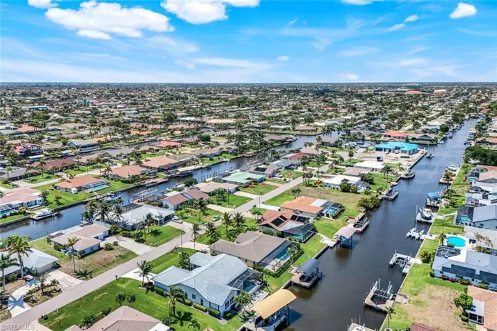Aerial perspective of suburban area featuring a large body of water