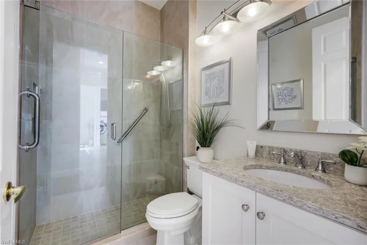 Full bath with vanity and a shower stall