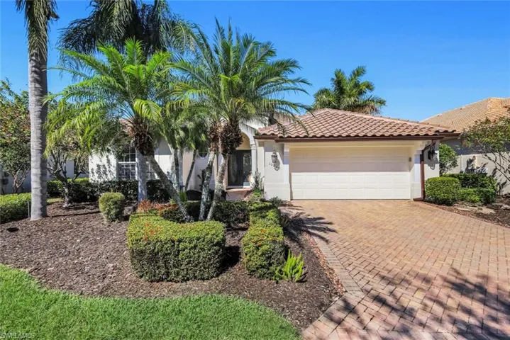 Mediterranean / spanish-style home with stucco siding, decorative driveway, a tiled roof, and an attached garage