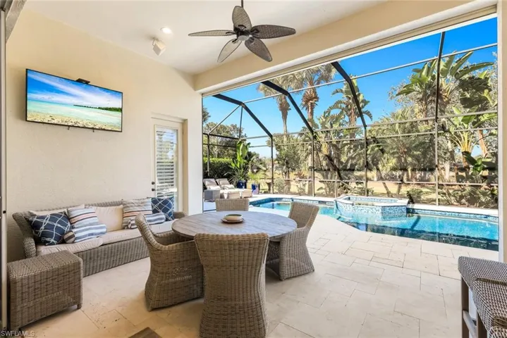 View of patio / terrace featuring outdoor lounge area, a sunroom, ceiling fan, a lanai, and a pool with connected hot tub