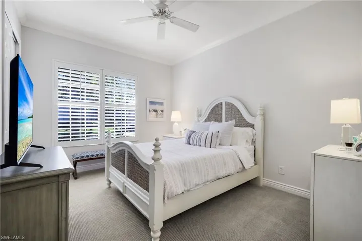 Bedroom with carpet flooring, a ceiling fan, and crown molding