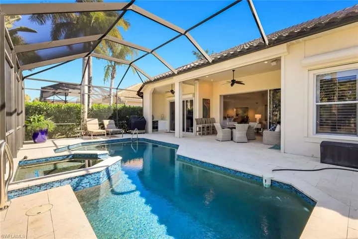 Integrated pool / spa featuring a patio, a sunroom, glass enclosure, outdoor dining area, and a grill