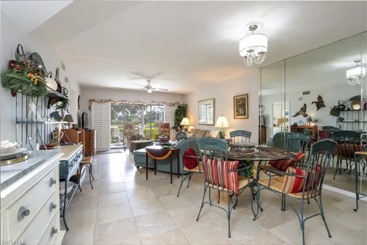 Dining area featuring ceiling fan and a chandelier