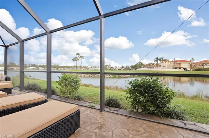 Unfurnished sunroom featuring a water view, plenty of natural light, and a residential view