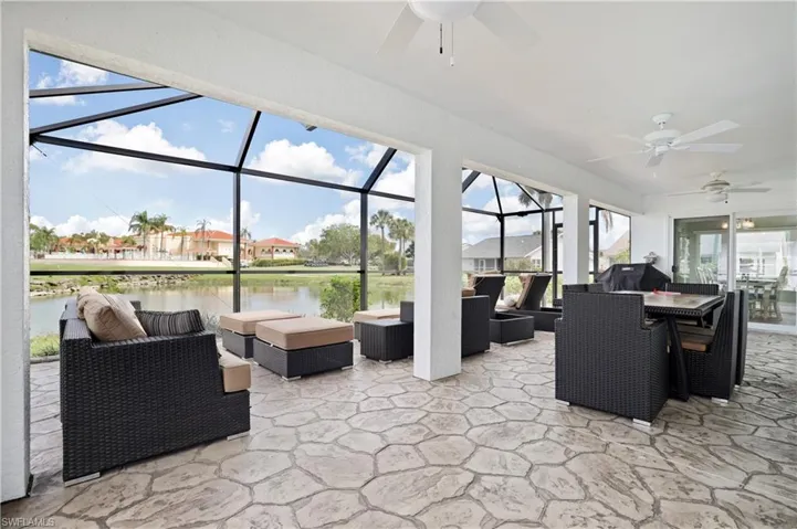View of patio / terrace with ceiling fan, a sunroom, an outdoor living / dining area, a residential view, and glass enclosure