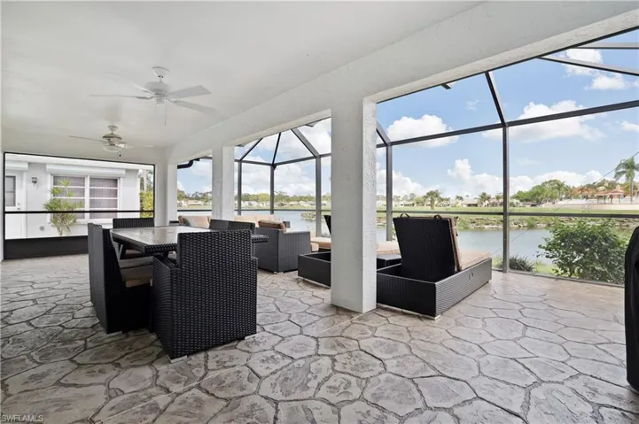 Sunroom / solarium featuring outdoor lounge area, ceiling fan, a water view, and a patio area