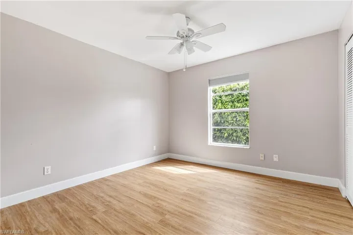 Spare room featuring light wood-style flooring and ceiling fan