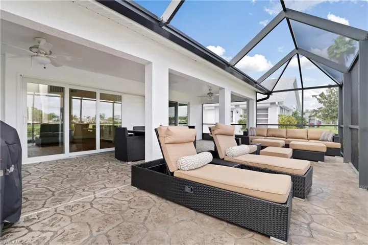View of patio / terrace with ceiling fan, outdoor furniture, a sunroom, and glass enclosure