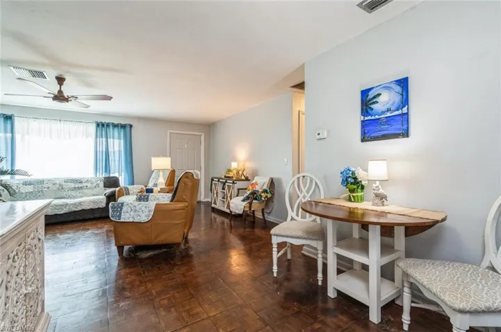 Living room with dark parquet floors and ceiling fan