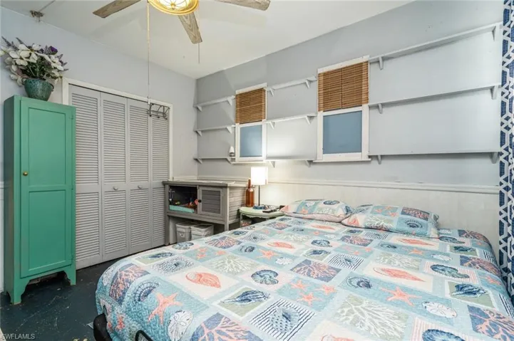 Bedroom featuring a closet, concrete flooring, and ceiling fan