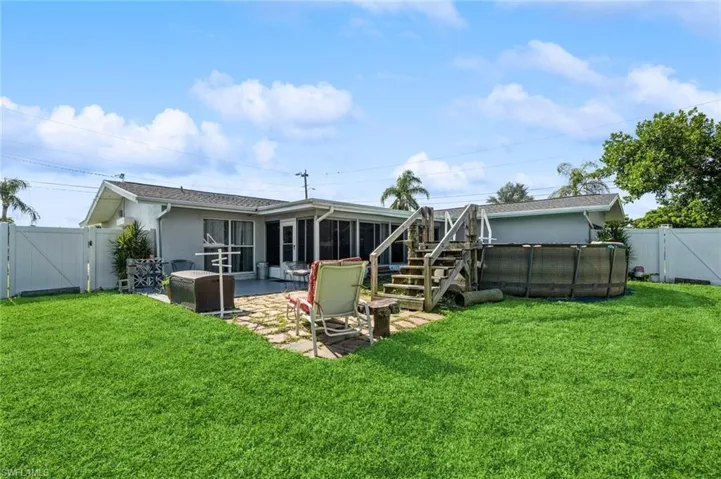Back of house featuring a patio area and a lawn