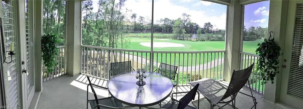 Picturesque lanai with view of golf course and water