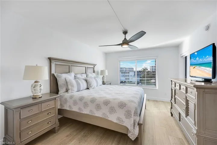 Bedroom with light wood-style flooring and a ceiling fan