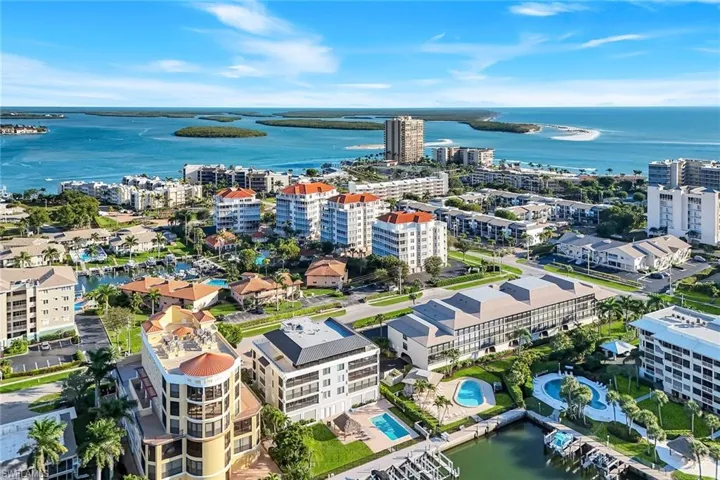 View of urban area with a nearby body of water and a pool area