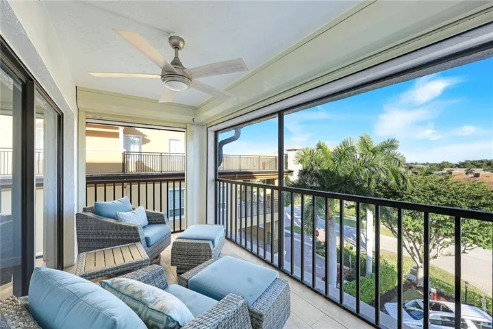 Balcony with a sunroom, a ceiling fan, and outdoor lounge area
