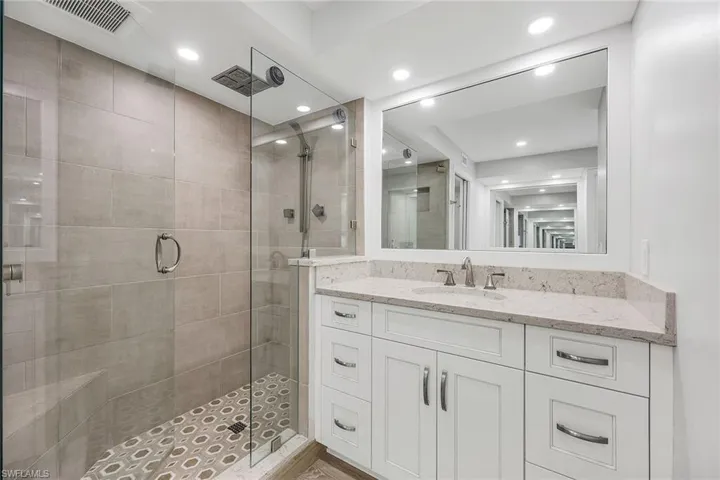 Full bath with vanity, a stall shower, and recessed lighting