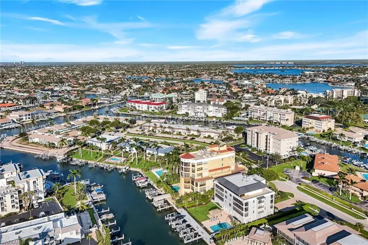 Aerial view of property's location featuring a large body of water and nearby urban area