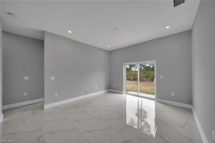 Spare room with light marble finish flooring and recessed lighting
