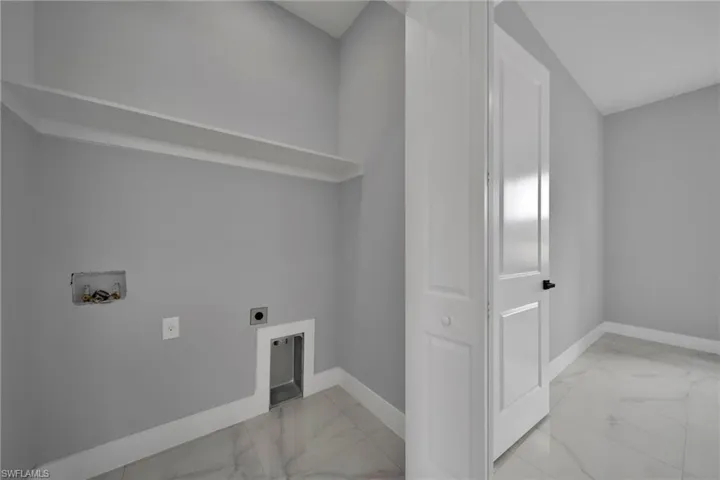 Laundry room with light marble finish flooring, washer hookup, and electric dryer hookup