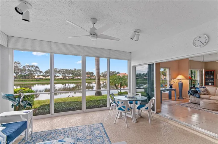 Closed in lanai  featuring ceiling fan and a water view