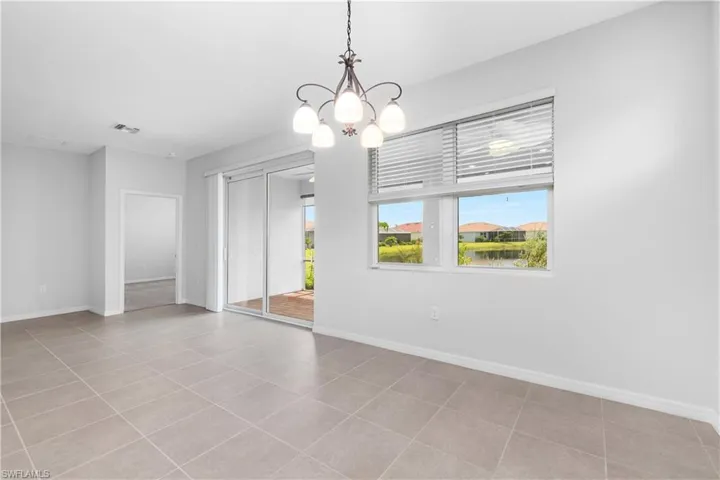 Dining area with tile flooring and chandelier