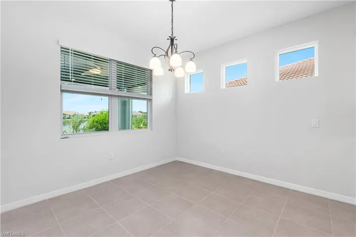 Dining area with tile flooring and chandelier