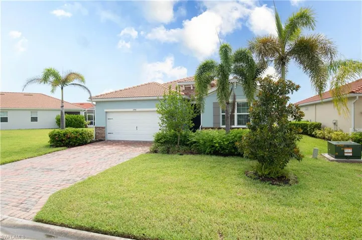 View of front of house featuring a garage and a front yard