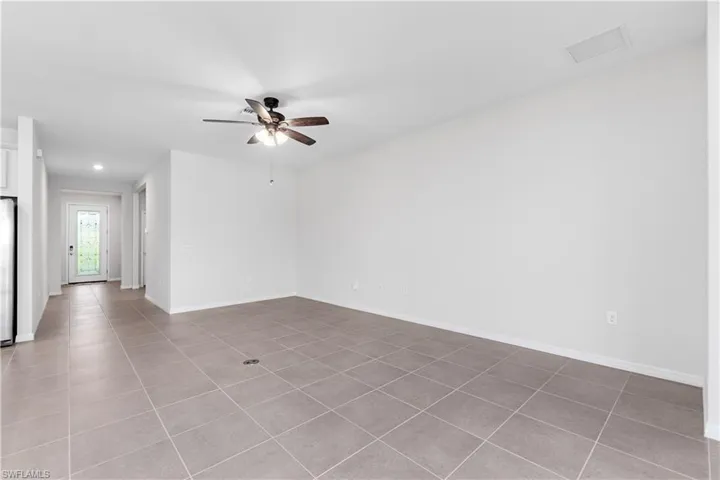 Living area with tile flooring and ceiling fan