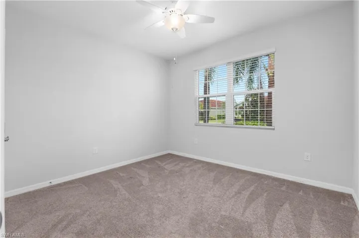 Carpeted bedroom with ceiling fan