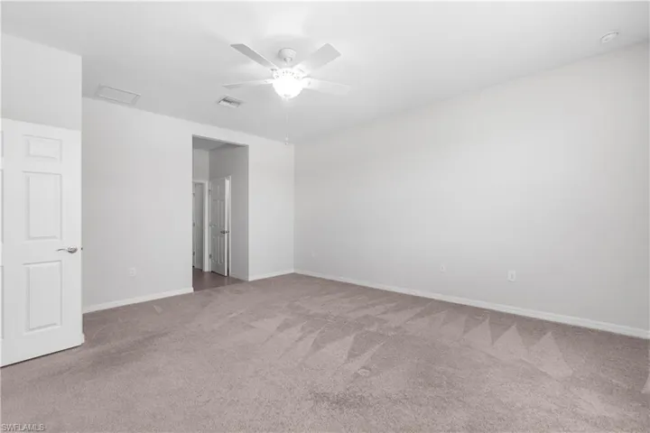 Master bedroom featuring carpet and ceiling fan