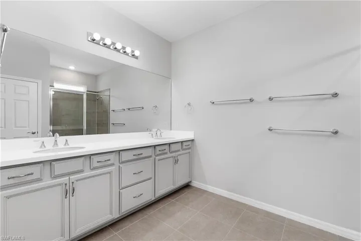 Bathroom featuring dual vanity and tile flooring