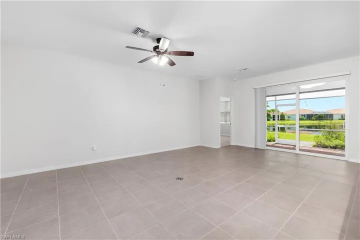 Living area with tile flooring and ceiling fan