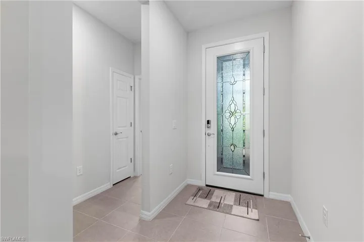 Entrance foyer featuring light tile patterned flooring